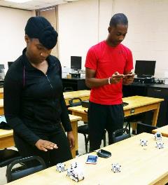 Raquel Boulware, Donald Davis test robots while conducting research at Claflin in human computer interaction